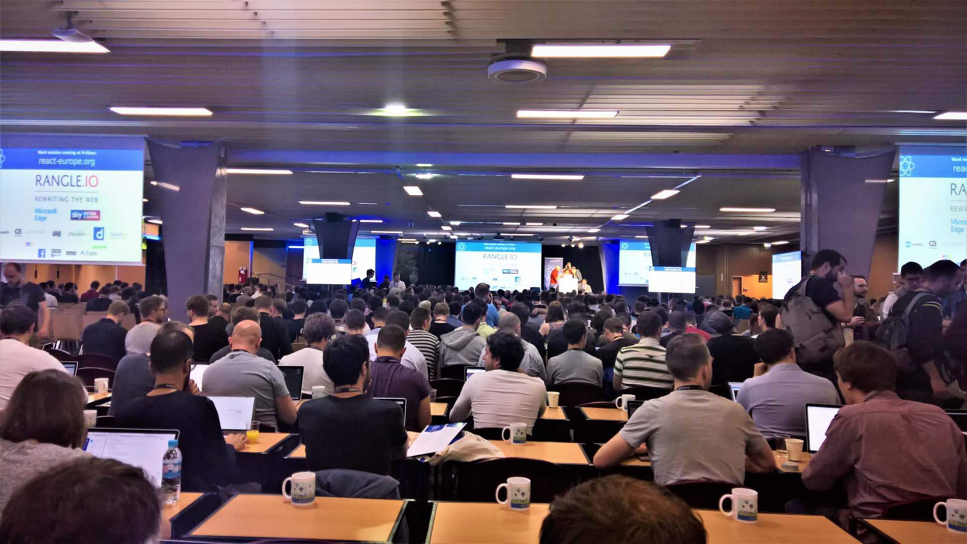 The conference hall, full to bursting with developers waiting for Andrew Clark's keynote to start...